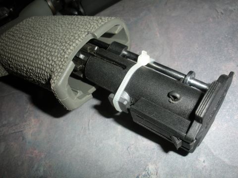1996 Ford Bronco - Internal components of a rifle, held together with a white zip tie.