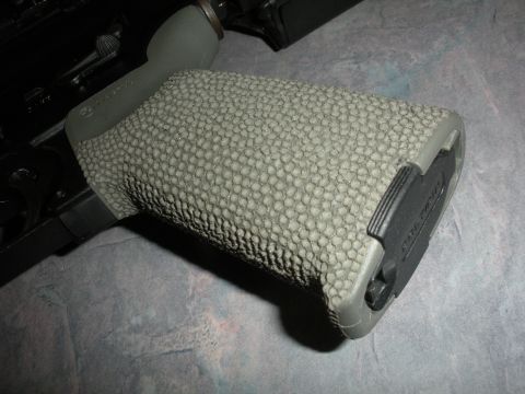 1996 Ford Bronco - A close-up view of a textured gun grip, showing its detailed surface and black accents.