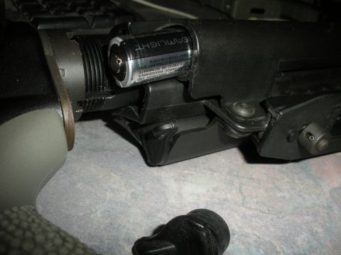 1996 Ford Bronco - Close-up of a firearm component with a battery inserted.