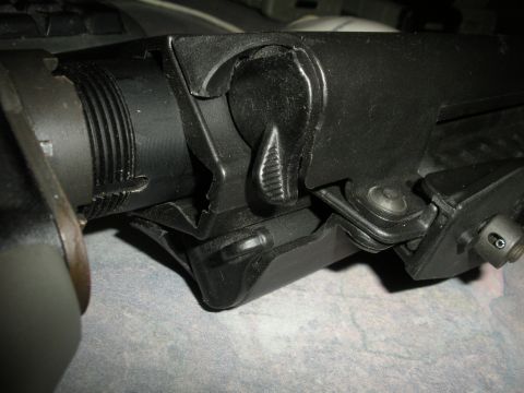 1996 Ford Bronco - A close-up view of a black firearm receiver, showing intricate mechanical details.