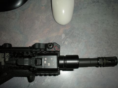 1996 Ford Bronco - A firearm with a tactical light and muzzle brake is shown in this close-up view.