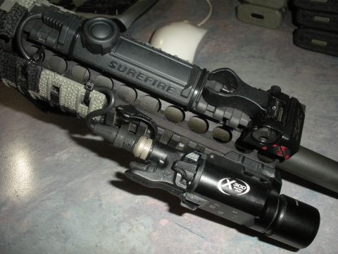 1996 Ford Bronco - Close-up of a SureFire weapon light and a laser sight attached to a tactical rail.