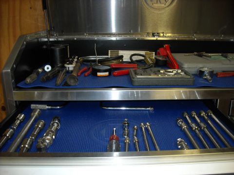 1979 Ford F-150 - Organized tool chest displays a variety of sockets, wrenches, and other hand tools laid out on blue mats.