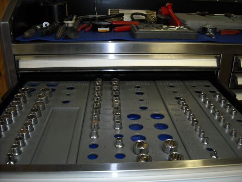 1979 Ford F-150 - A drawer from a tool chest displays a neatly organized socket set and various other hand tools.