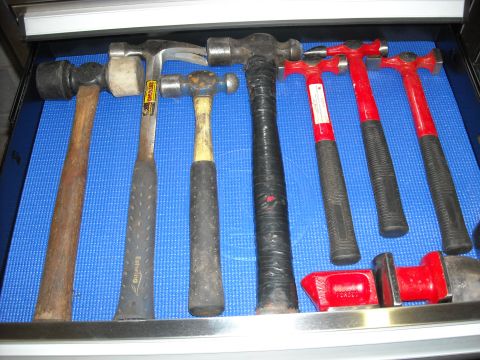1979 Ford F-150 - A collection of various hammers organized in a tool drawer.