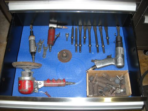 1979 Ford F-150 - A collection of air-powered automotive tools is neatly organized in a tool drawer on a blue mat.