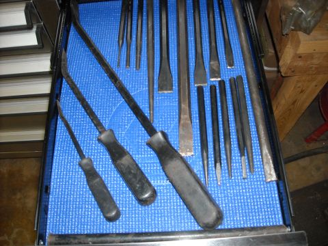 1979 Ford F-150 - A collection of pry bars and punches are neatly organized in a blue-lined tool drawer.