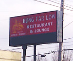 2006 Subaru Legacy - A sign for Hung Far Low Restaurant & Lounge is visible against a cloudy sky.