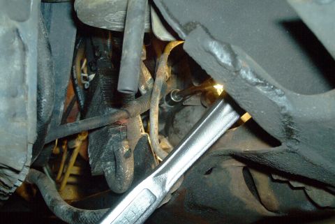 1993 Ford Taurus - Loosen the upper starter nut on the bolt, and remove the ground wire.