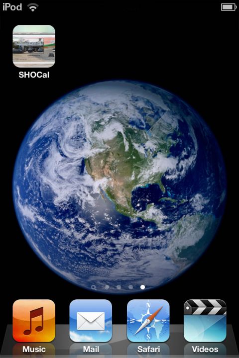 1993 Ford Taurus - The iPod home screen displays a wallpaper of Earth and several application icons.
