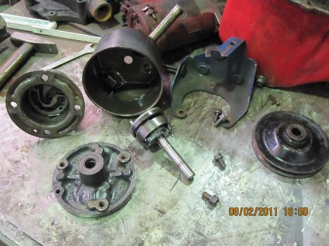 1973 Ford Ranchero - Various disassembled vehicle components are laid out on a workbench, suggesting a repair or rebuild process.