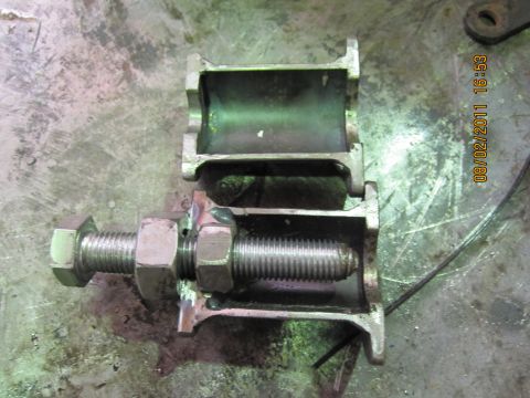 1973 Ford Ranchero - A metal component with a threaded bolt and nuts is shown, likely a part for a vehicle's suspension system.