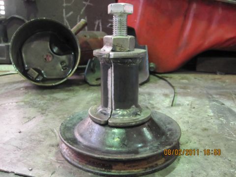 1973 Ford Ranchero - Close-up of a pulley assembly, likely a spare part, resting on a workbench.