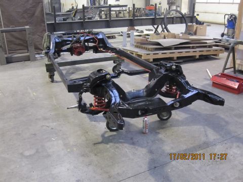 1973 Ford Ranchero - A vehicle chassis, likely undergoing restoration, is shown on wheels in a workshop setting.