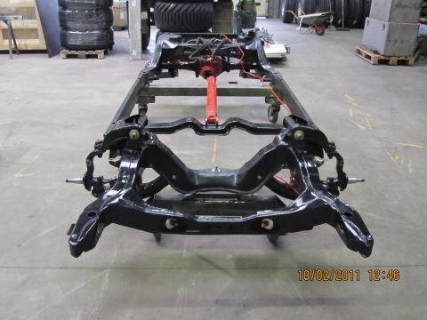 1973 Ford Ranchero - The bare chassis of a vehicle is shown, with the front suspension components clearly visible.