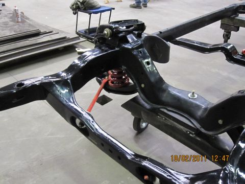 1973 Ford Ranchero - Close-up view of a vehicle's chassis and suspension system, likely undergoing restoration or repair.