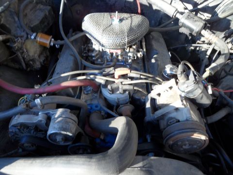 1989 Ford Bronco - Engine bay of a 1989 Ford Bronco, showing the V8 engine and its components.