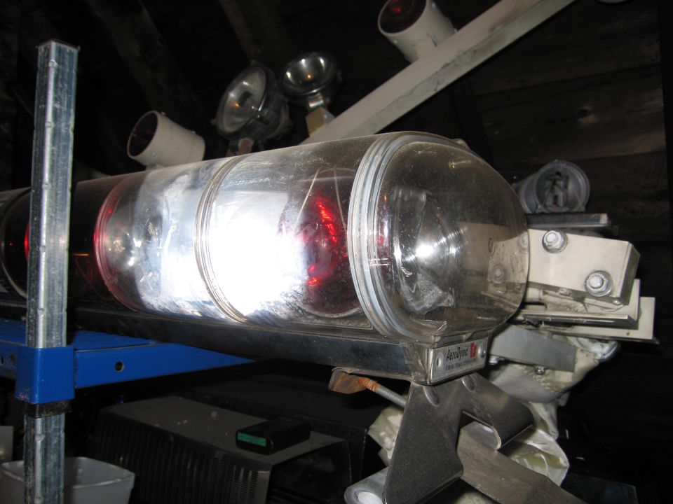 Emergency light bar with clear dome and red lights, mounted on metal brackets