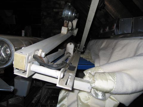 2001 Ford Crown Victoria - Close-up of a mechanical assembly with a motor and lamp housing, partially covered by a blanket.