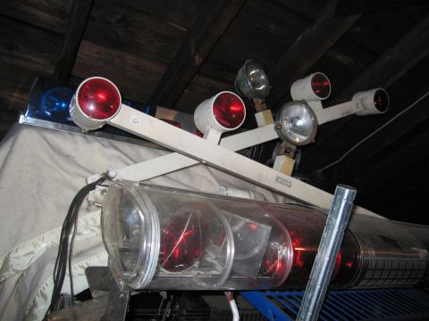 2001 Ford Crown Victoria - An emergency light bar with multiple red and blue lights and spotlights is stored indoors.