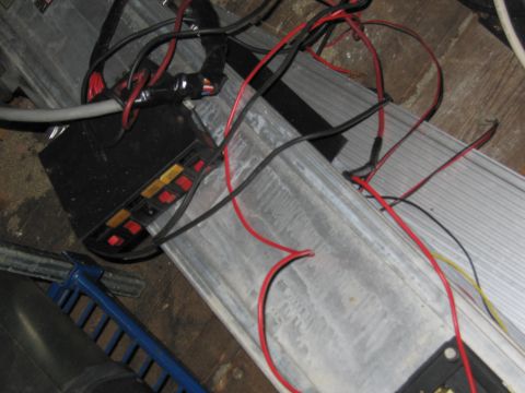 2001 Ford Crown Victoria - A close-up view of a vehicle's electrical fuse box and wiring harness.