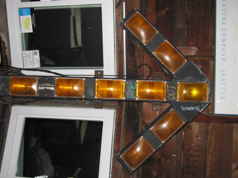 2001 Ford Crown Victoria - Arrow light bar with multiple amber lenses, mounted near windows and wooden walls.