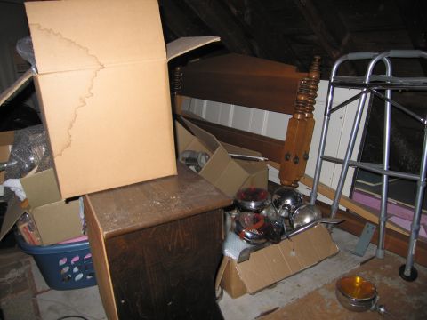 2001 Ford Crown Victoria - Various car lights and other items stored in a cluttered attic space.