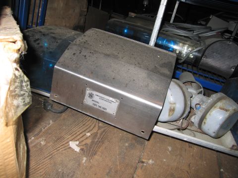 2001 Ford Crown Victoria - A dusty piece of emergency equipment is shown, with a label indicating the manufacturer and model number.