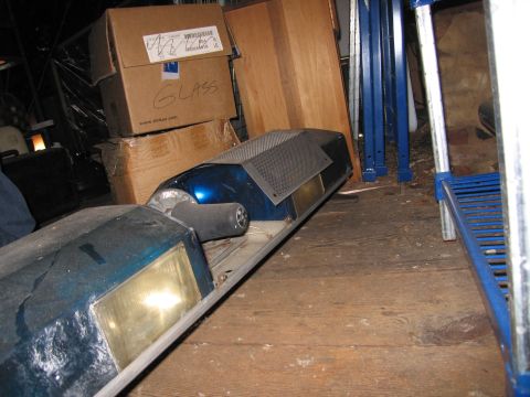2001 Ford Crown Victoria - A blue light bar with yellow lenses and a black handle is stored indoors.