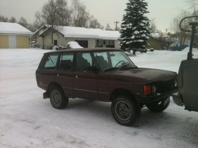 Maroon Range Rover Classic in snow, 3/4 front view
