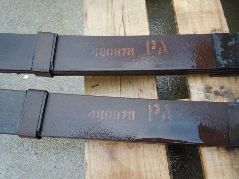 1972 Chevrolet Camaro - Leaf springs with part number 480870 stamped on them, resting on wooden planks.