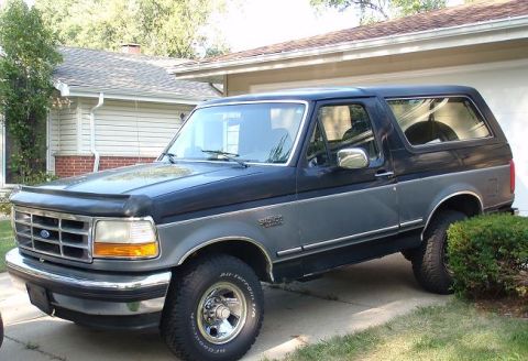 1993 Ford Bronco - This two-tone gray and black Ford Bronco is shown from the front three-quarter view.