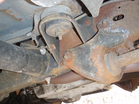 1993 Ford Bronco - Close-up view of rusted underbody suspension components, with a watermark indicating the source.