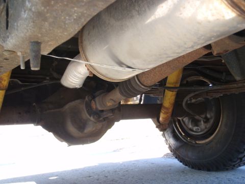 1993 Ford Bronco - Undercarriage view showing the rear axle assembly and exhaust system of a vehicle.