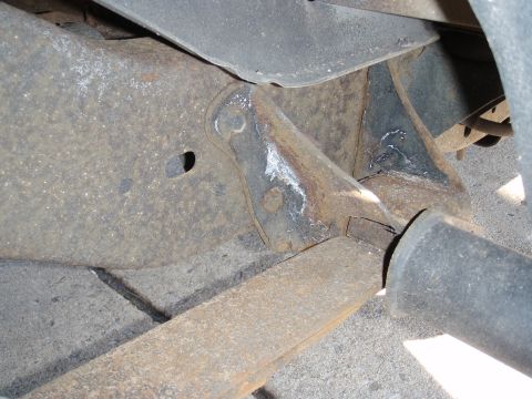 1993 Ford Bronco - Detail of a vehicle's undercarriage, showing significant rust on the frame and suspension parts.