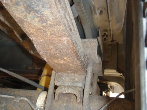 1993 Ford Bronco - Underside view of a vehicle's suspension system, showing significant rust on the leaf springs.
