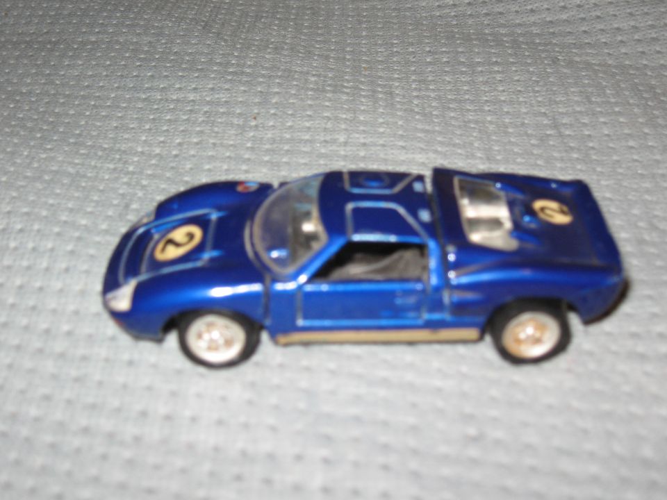 Blue toy car with racing number 2 on hood and side