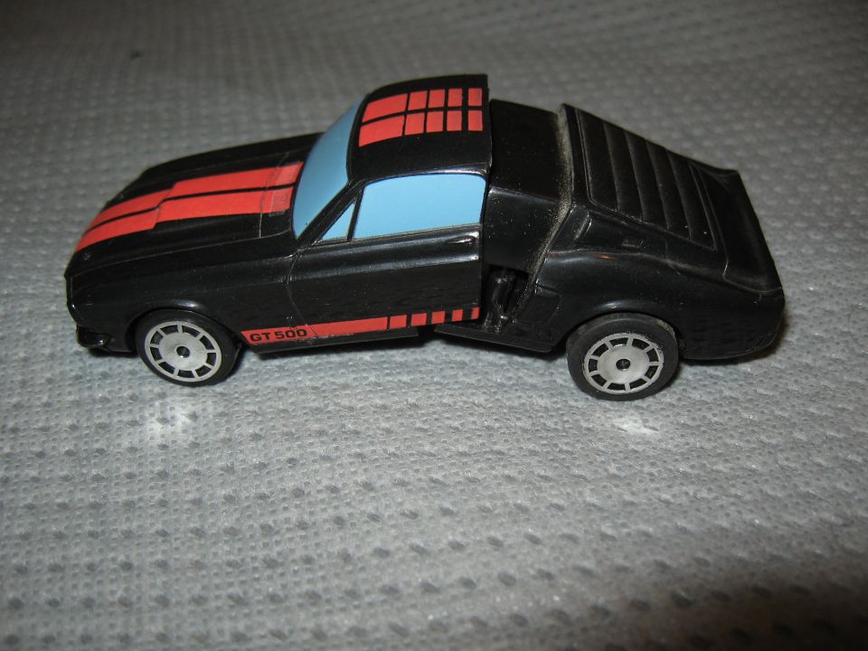 Black toy car with red stripes and 'GT 500' on the side