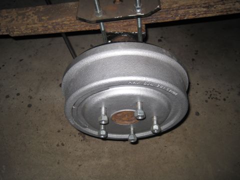 1979 Ford Bronco - Close-up of a drum brake assembly, likely a replacement part, mounted on a vehicle's suspension.