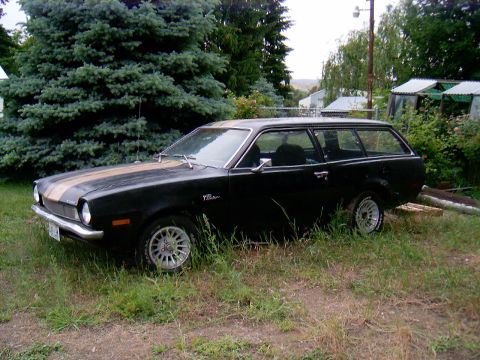1978 Ford Mustang II - This black station wagon features gold racing stripes and is identified as a Pinto by its badging.