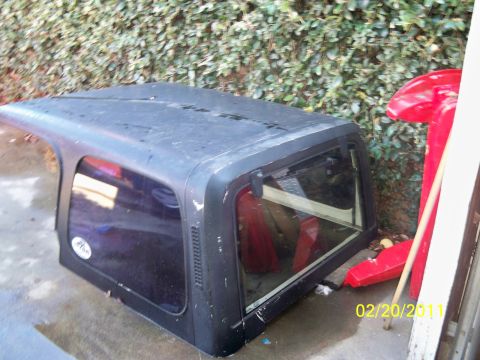 1992 Jeep Wrangler - This is a black hardtop for a Jeep Wrangler, shown with tinted windows and some interior components visible.