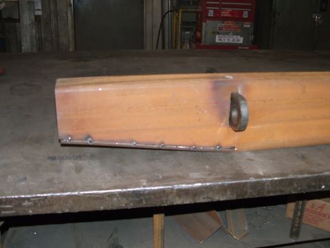 1978 Ford Bronco - A metal component, possibly a custom part, is shown on a workbench with visible welds.