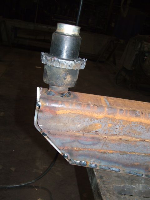1978 Ford Bronco - A close-up view of a welded metal component, possibly a suspension part, with a cylindrical element affixed.