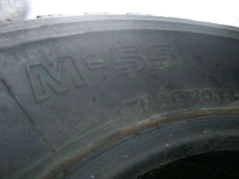 2005 Dodge 3500 - A close-up view of a tire's sidewall, displaying the model designation M-55 and the word TRACTION.
