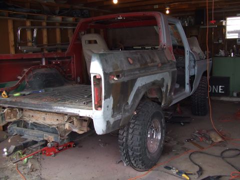 1979 Ford Bronco - This 1978 Ford Bronco is in a garage, seemingly undergoing a significant restoration project with its body panels exposed.