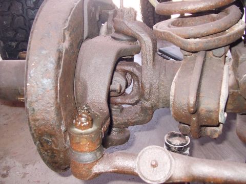 1979 Ford Bronco - This image shows the front suspension components of a vehicle, including the steering linkage and part of the tire.