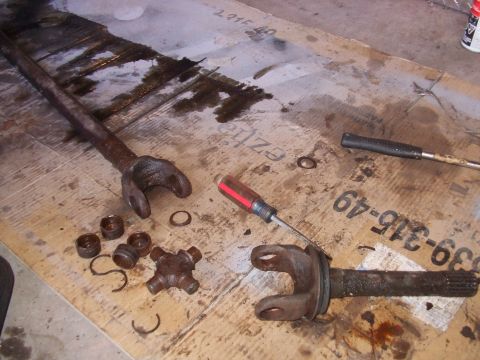 1979 Ford Bronco - Disassembled driveshaft components lie on a surface with visible markings and oil stains.