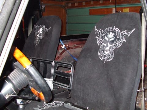1979 Ford Bronco - The interior of a 1979 Ford Bronco features custom seat covers adorned with a skull graphic.