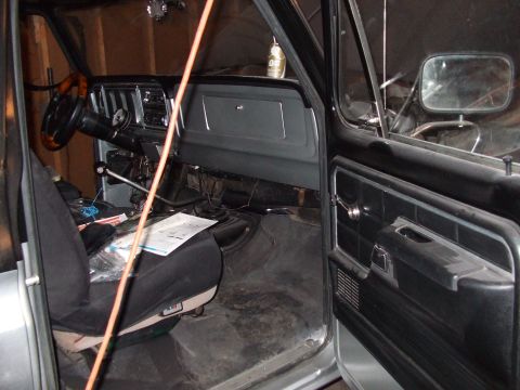 1979 Ford Bronco - The interior of a 1979 Ford Bronco is visible, including the dashboard and driver's seat.