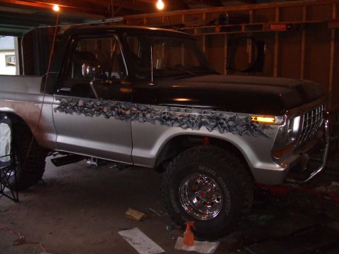1979 Ford Bronco - This lifted Ford Bronco features custom skull graphics along its two-tone paint job.